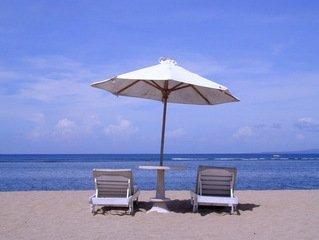 Umbrella and lounge chairs overlooking the ocean on the beach